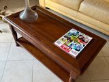 a coffee table with a magazine on it in a living room
