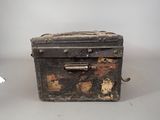 an old suitcase sitting on a table with a piece of paper