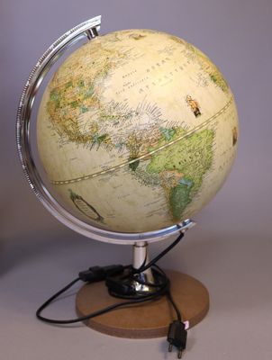 a small globe on a wooden stand with a cable