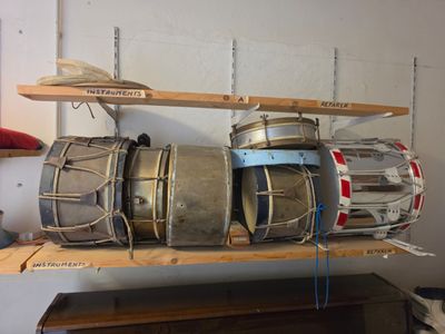 a shelf that has a bunch of drums on top of it