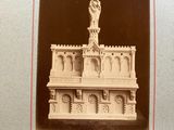 an old photo of a statue of a man on top of a building