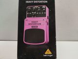 the box of a pink guitar effects pedal sits on a white surface