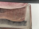 a close up of a metal object on a white surface
