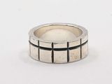 a close up of a silver ring on a white surface