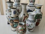 many vases that are sitting on a table