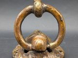an antique bronze figurine of a turtle with a ring around its neck