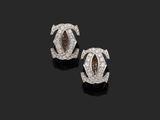 a pair of diamond and white gold earrings