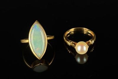 two gold rings with oplite and pearl