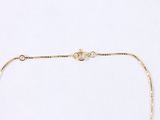 a close up of a gold chain necklace on a white background