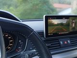 a car dashboard with a monitor and a steering wheel