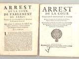 deux pages d'un vieux livre, sur lesquelles figurent des inscriptions, posées sur une table