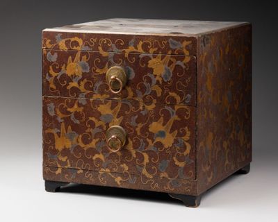 a small wooden chest with a floral design on it