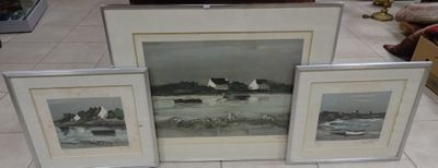 three framed pictures on the floor of a living room