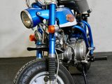 a small blue motorcycle parked in a garage