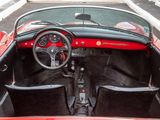 a red and black car with a steering wheel and dashboard