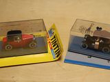 two toy cars that are in a box on a table