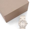 the watch is white in color and has a box with a watch on it