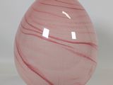 a pink lamp that is sitting on a table