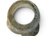 a ring made out of cement sitting on a white surface