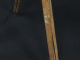 a wooden tripod with a wooden handle on a black background