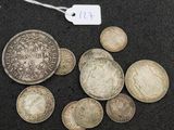 some silver coins are sitting on a black surface with a price tag