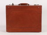 brown leather suitcase on a white surface with a white background