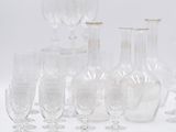 a lot of wine glasses and vases on the table