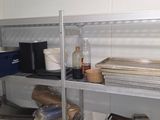 a metal shelf with various items on it in a room