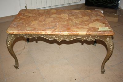 a marble top coffee table on a tile floor