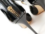 pair of black high heeled shoes with a zipper on the side