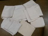 a pile of white pants sitting on the floor