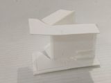 a small white object sitting on a white surface