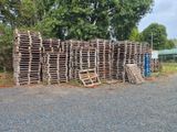 un tas de palettes en bois posé au bord de la route