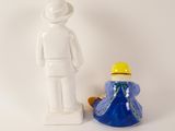 a figurine of a man and a woman next to each other