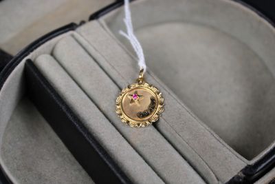 a gold locke with a picture of a woman on it