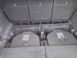 a trunk of a car with four suitcases in it
