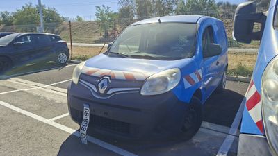 a small blue van parked in a parking lot next to a car