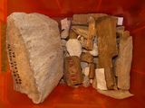 a red container filled with rocks and logs