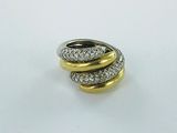 a close up of a gold and silver ring on a white surface