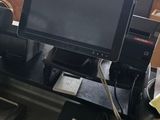 a desk with a computer monitor and a printer on it