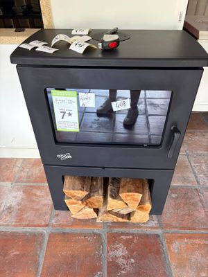 a black stove with logs stacked on top of it