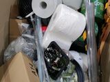 a cardboard box filled with toilet paper, toilet paper rolls, and other items