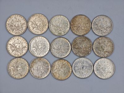 six different types of coins are arranged in a row on a white surface