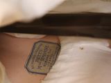 a woman laying in a bed with a tag on her chest