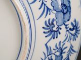 a blue and white plate with blue flowers on it