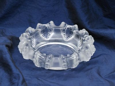 a clear glass bowl on a blue cloth