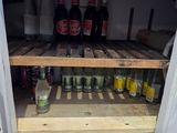 many bottles of beer on the shelves in the refrigerator