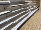 empty shelves in the middle of a store that is empty