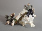 a figurine of a man sitting on top of a cow
