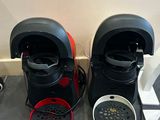 two coffee makers sitting on the floor next to each other